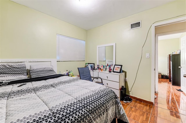 bedroom with hardwood / wood-style flooring