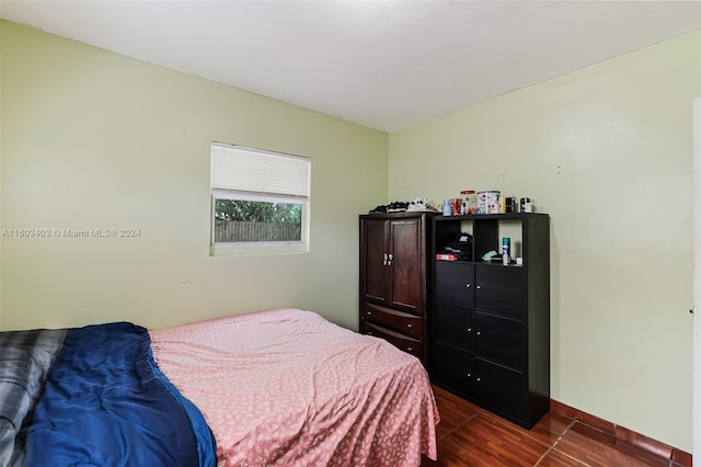 bedroom with dark hardwood / wood-style floors