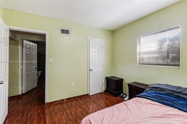 bedroom with dark hardwood / wood-style floors