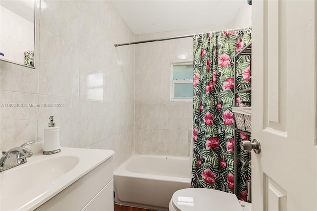 full bathroom featuring tile walls, toilet, shower / tub combo, and oversized vanity