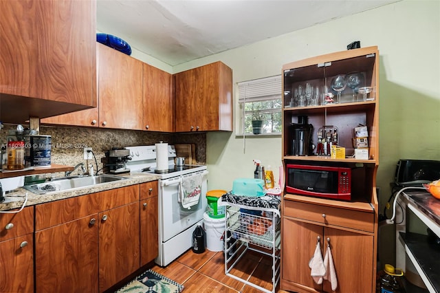 kitchen with sink, electric stove, backsplash, and black microwave