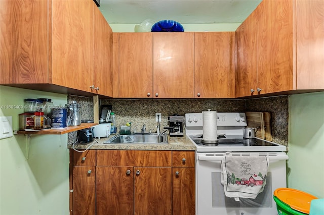 kitchen featuring sink, backsplash, and white range with electric stovetop