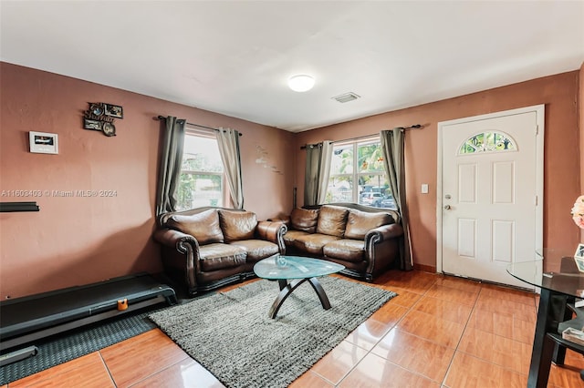 living room featuring a wealth of natural light and light tile floors