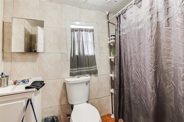 bathroom featuring tile walls, large vanity, and toilet