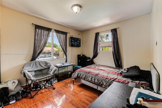 tiled bedroom with multiple windows