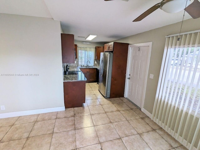 kitchen featuring stainless steel fridge, sink, tasteful backsplash, light tile flooring, and ceiling fan