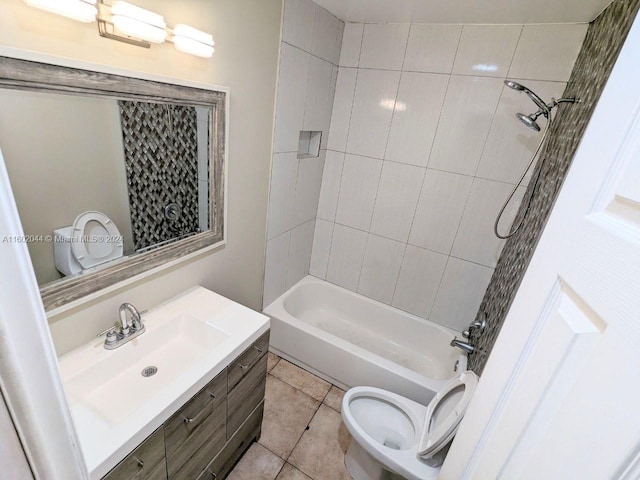 full bathroom with tile floors, toilet, vanity, and tiled shower / bath