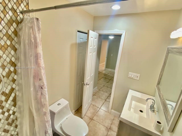 bathroom featuring tile flooring, oversized vanity, and toilet