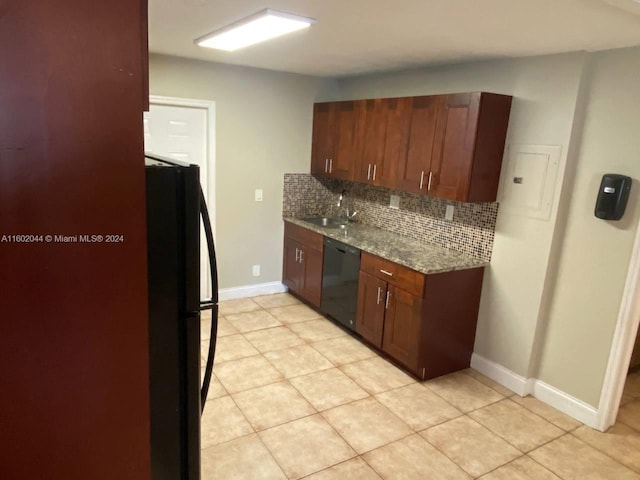 kitchen featuring tasteful backsplash, black appliances, light stone countertops, sink, and light tile floors