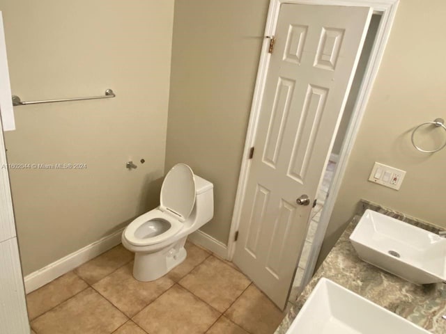 bathroom with tile floors and toilet