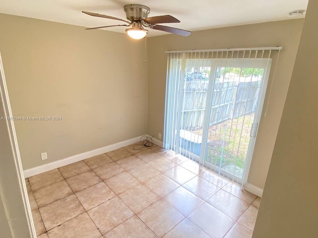 unfurnished room featuring ceiling fan and light tile floors