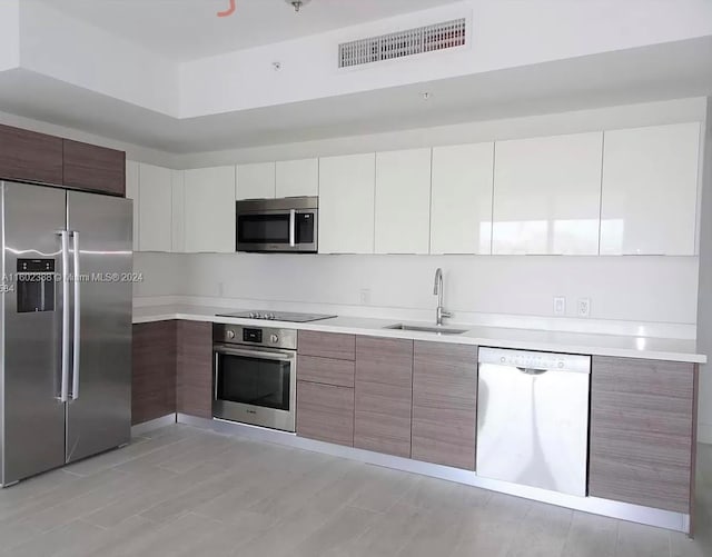 kitchen with white cabinets, sink, and stainless steel appliances