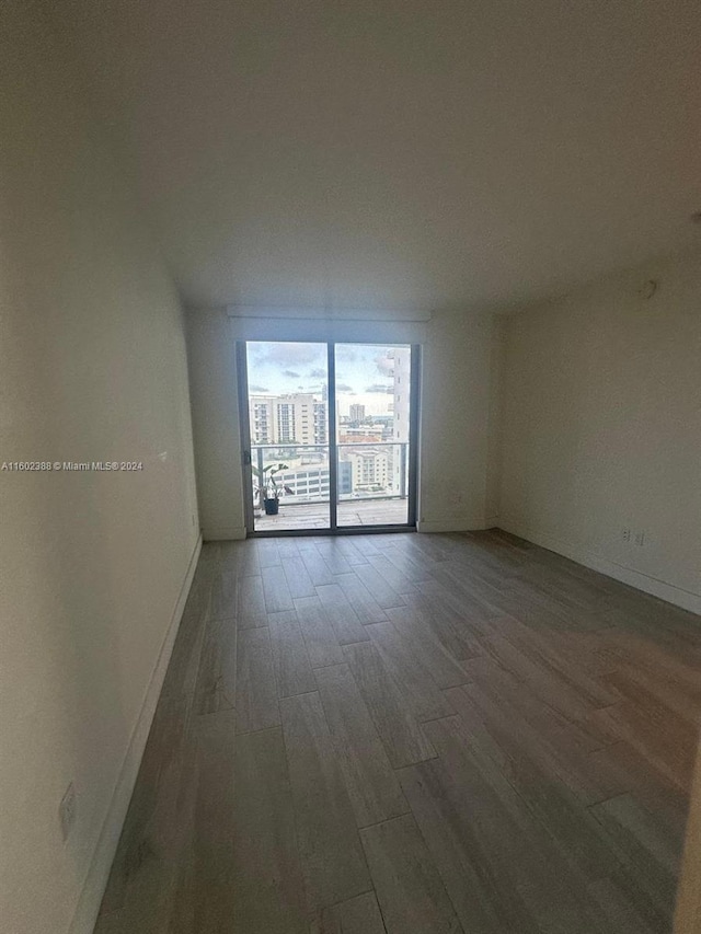 empty room with dark hardwood / wood-style floors