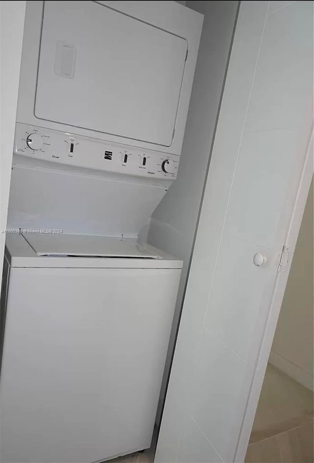 laundry room featuring stacked washer and clothes dryer