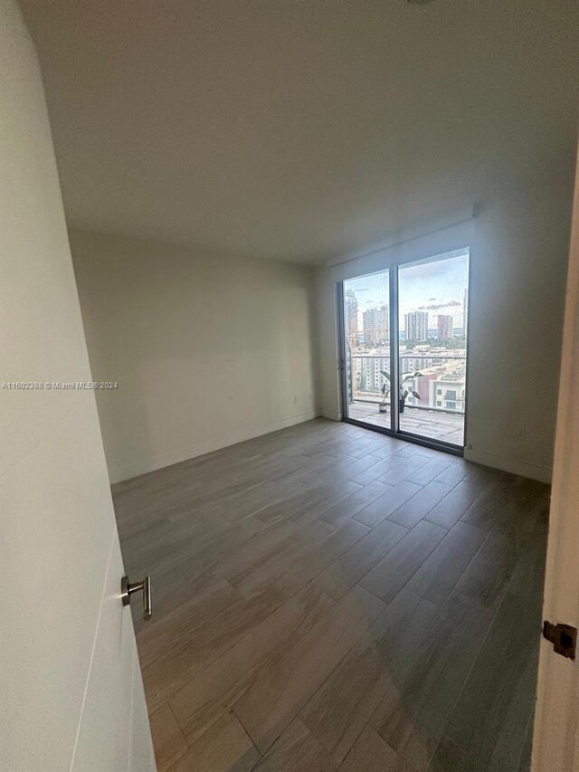 empty room with dark wood-type flooring