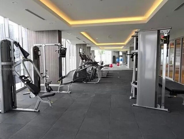 exercise room with a raised ceiling