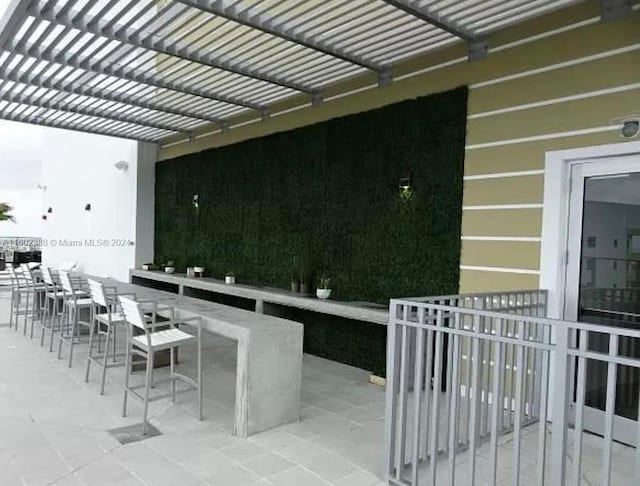 view of patio with a pergola and a bar