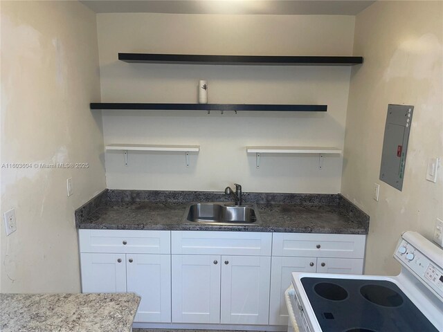 kitchen featuring white cabinetry, white electric range, sink, and electric panel