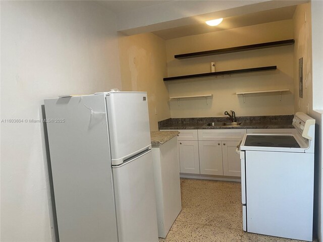 kitchen with white cabinetry, white appliances, and sink