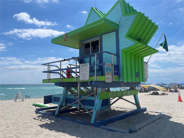 exterior space featuring a water view and a view of the beach