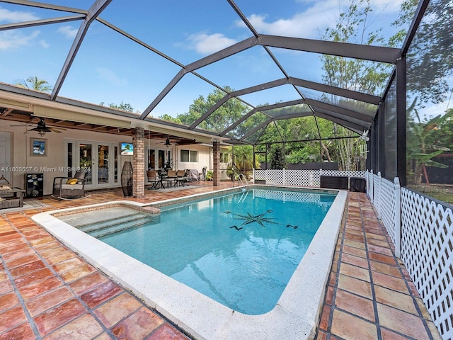 view of pool featuring french doors, ceiling fan, and a lanai