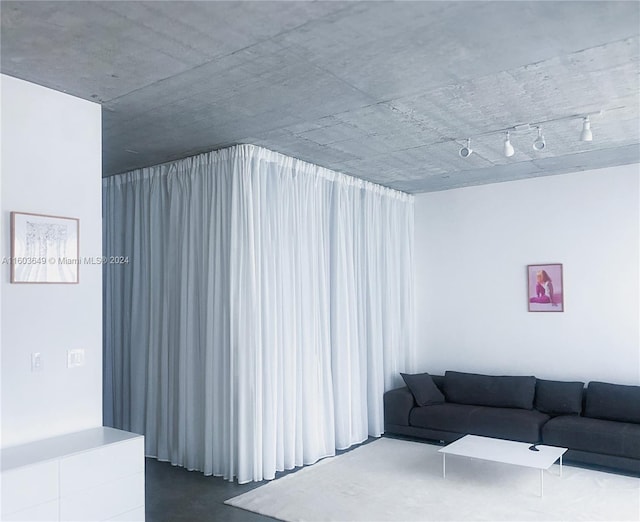 living room with concrete floors and track lighting