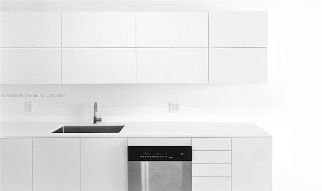 room details featuring white cabinets, dishwasher, and sink