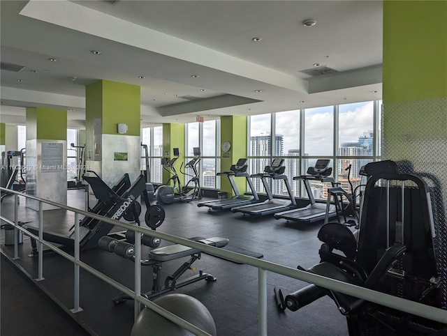 exercise room featuring a tray ceiling