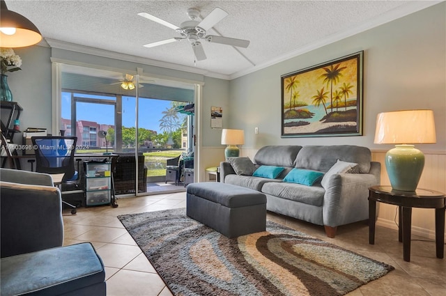 living room with tile floors, ceiling fan, a textured ceiling, and crown molding