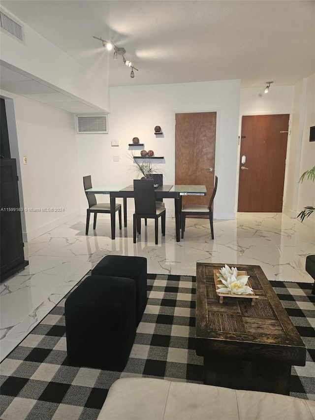 tiled living room featuring rail lighting