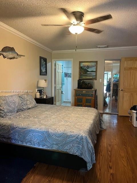 bedroom featuring dark wood-type flooring, ceiling fan, a textured ceiling, and crown molding