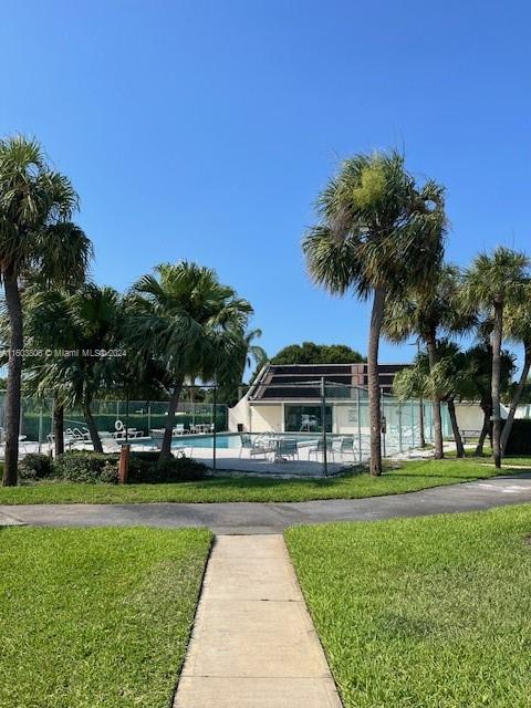 view of community with a lawn and a pool