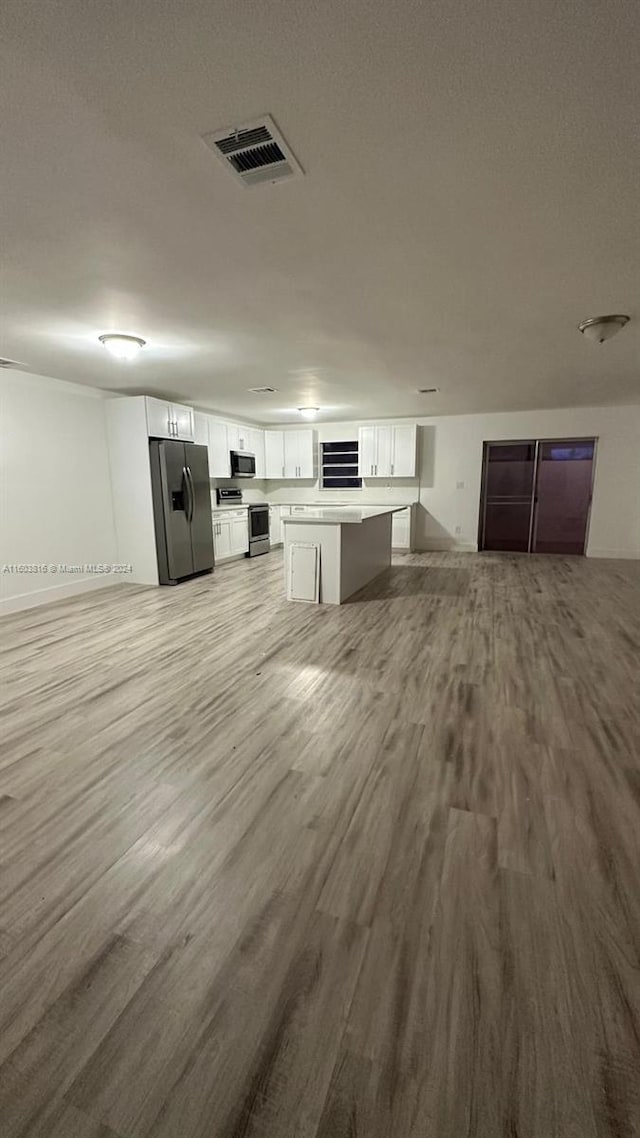 unfurnished living room featuring light hardwood / wood-style floors