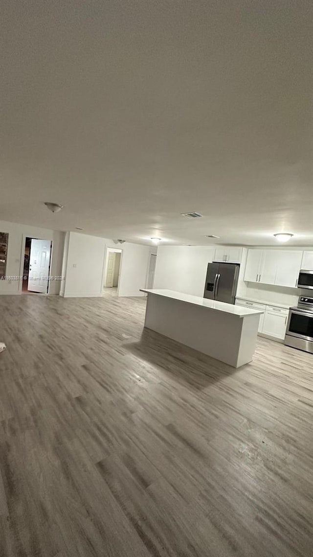 unfurnished living room with light wood-type flooring