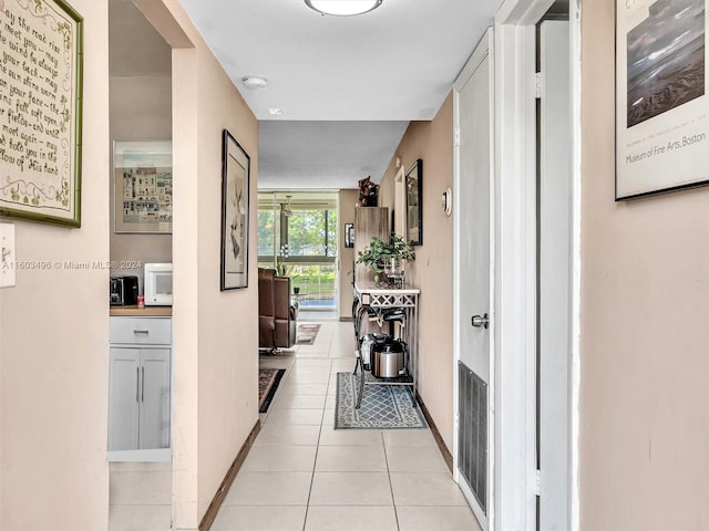 hall featuring light tile patterned floors