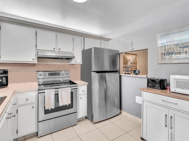 kitchen with white cabinets, light tile patterned floors, and stainless steel appliances