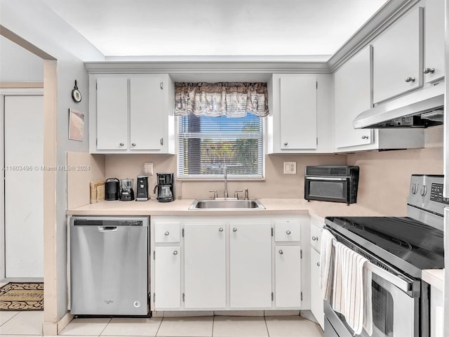 kitchen with white cabinets, appliances with stainless steel finishes, light tile patterned flooring, and sink