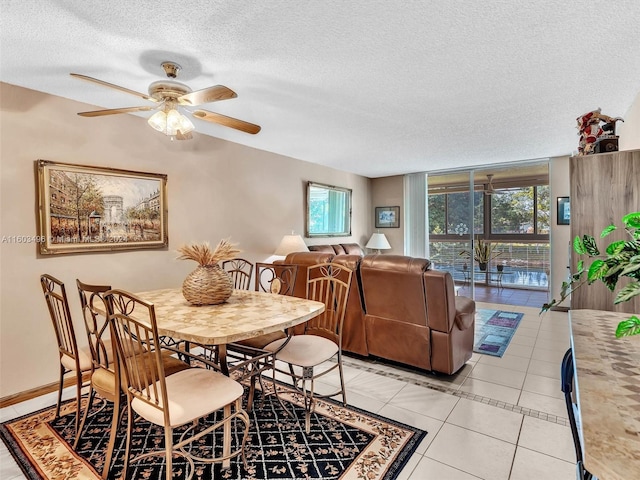 dining room with light tile patterned floors, a textured ceiling, and ceiling fan