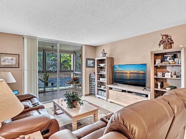 living room with floor to ceiling windows, light tile patterned floors, and a textured ceiling