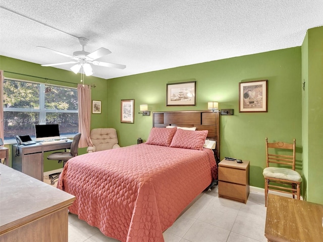 tiled bedroom with ceiling fan and a textured ceiling