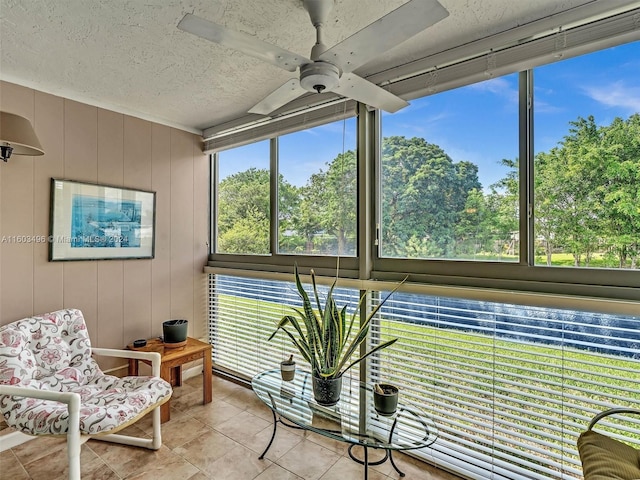 sunroom / solarium featuring ceiling fan