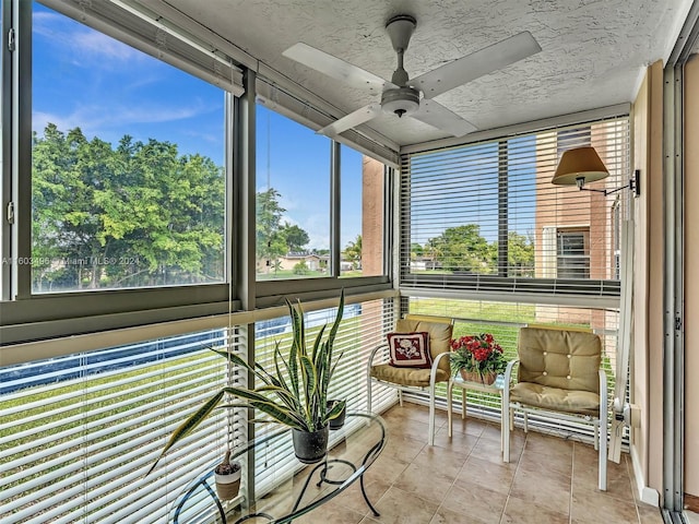 unfurnished sunroom with ceiling fan