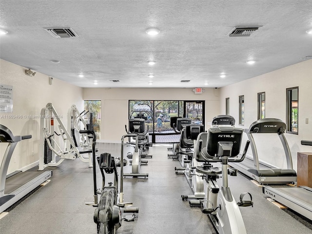 exercise room with a textured ceiling