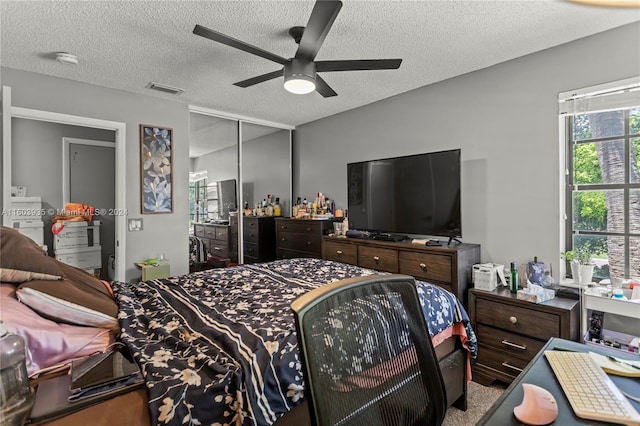 bedroom featuring a textured ceiling, a closet, and ceiling fan