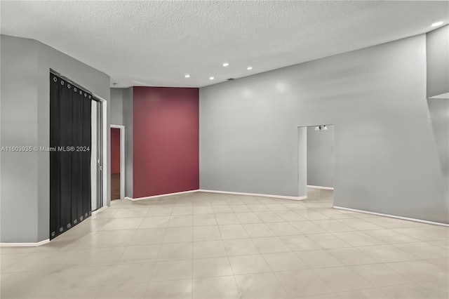 unfurnished room featuring a textured ceiling