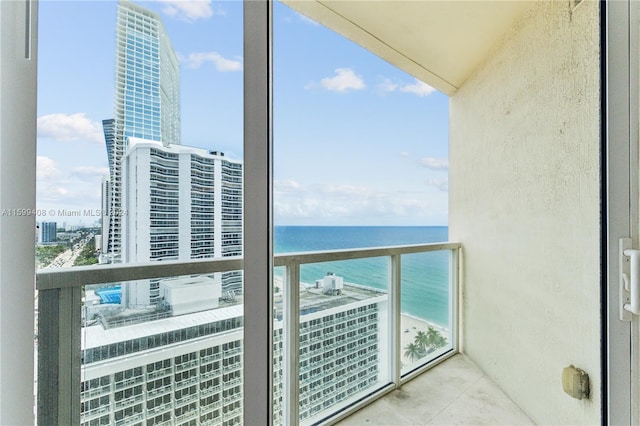 balcony featuring a water view and a view of the beach