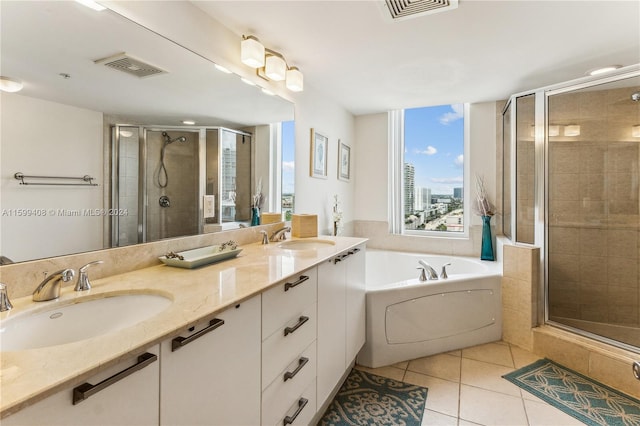 bathroom featuring plus walk in shower, tile patterned flooring, and vanity