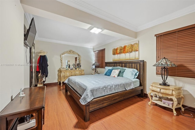 bedroom with hardwood / wood-style flooring and crown molding