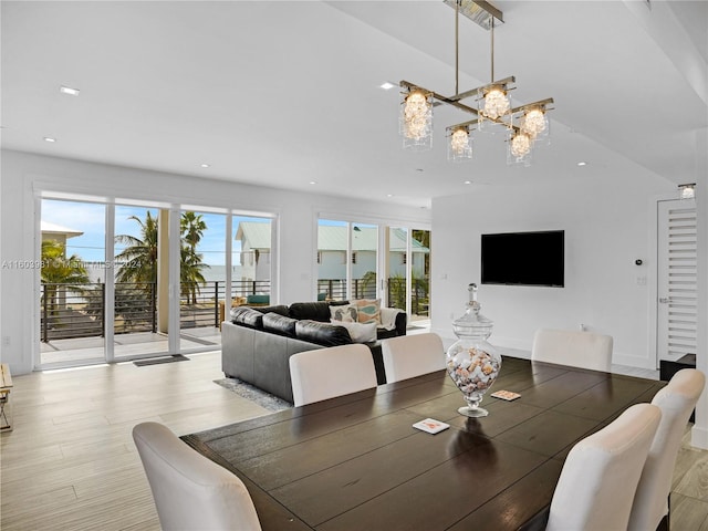 dining area featuring an inviting chandelier and hardwood / wood-style flooring