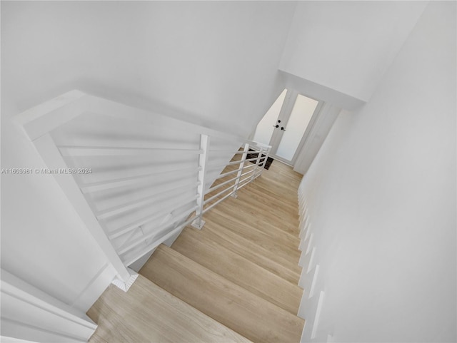 staircase with hardwood / wood-style floors